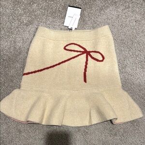 Beige Skirt with Red Bow Accent